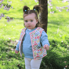 Load image into Gallery viewer, Kids Stylish Vest - Child Gilet - Baby Vest - baby gilet - outerwear - Spring floral design - model wearing side ways view - Little Scandi baby
